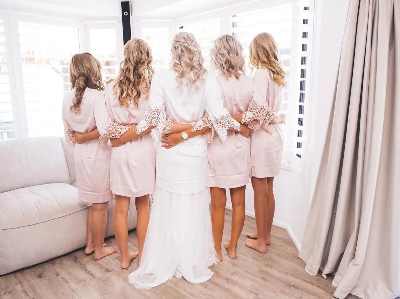 Bridal party hair and makeup Newcastle, bridesmaids in blush robes on the wedding morning